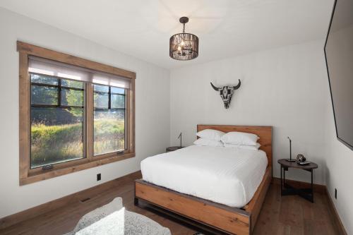 a bedroom with a bed and a window at Lodge at Whitefish Lake in Whitefish