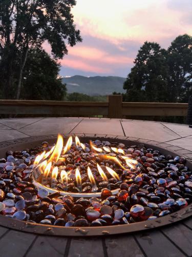 a fire pit with a bunch of rocks around it at Sunshine Hill in Fairview
