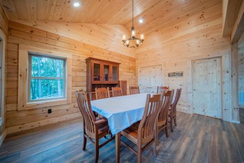 a dining room with a table and chairs at Sunshine Hill in Fairview