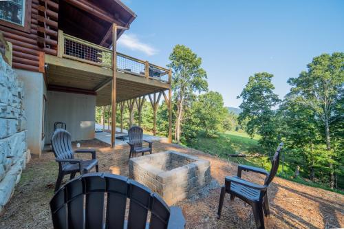 a patio with four chairs and a fire pit at Sunshine Hill in Fairview