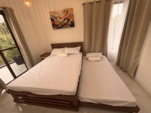 Un ou plusieurs lits dans un hébergement de l'établissement Villa Serene Resort