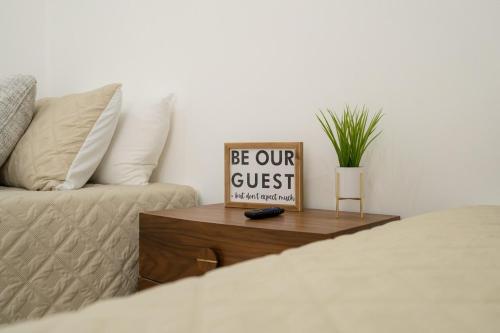 a guest room with a bed and a table with a sign at Cabo San Lucas House, 2Bedroom, 2Bathrooms,Pool, Rooftop views in El Pueblito