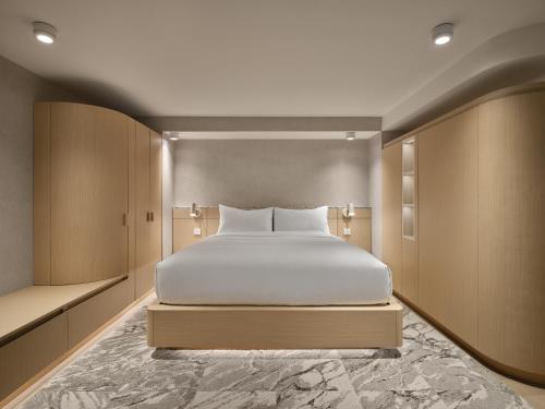 a bedroom with a white bed in a room at CORNER - Luxury Serviced Apartments in Montréal