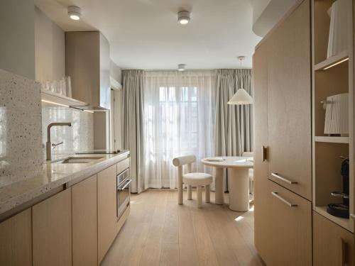 a kitchen with a table and a dining room at CORNER - Luxury Serviced Apartments in Montréal