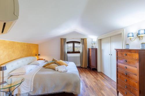 a bedroom with a large bed and a glass table at Villa Il Castellaccio in Rimini