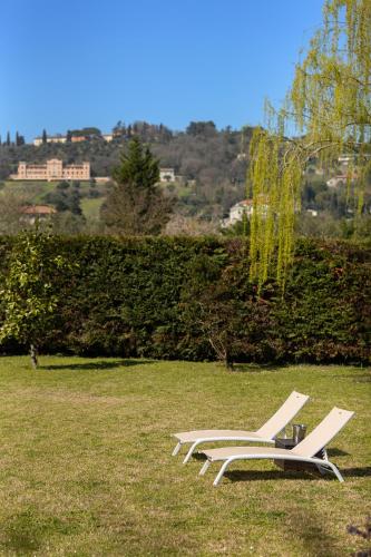 a lounge chair sitting on the grass in a field at Villa Il Castellaccio in Rimini