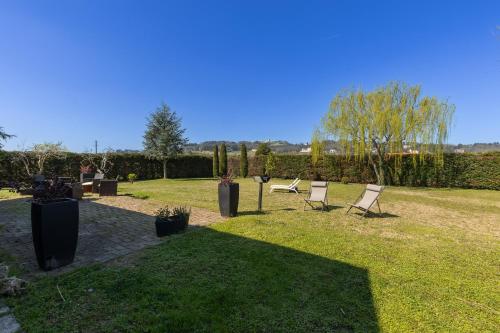 a group of chairs in the grass in a yard at Villa Il Castellaccio in Rimini