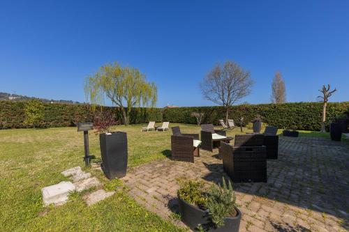 a group of chairs sitting in the grass at Villa Il Castellaccio in Rimini