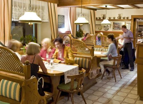 a group of people sitting at tables in a restaurant at Landgasthof Zur schönen Wienerin in Marbach an der Donau