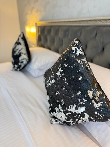two black and white pillows on a bed at Krystal Boutique Mansion in Hunedoara