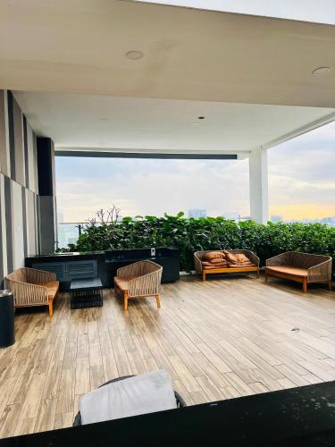 a patio with a couch and chairs on a building at The Luxe KLCC by Homestay in Kuala Lumpur
