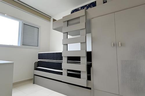 a room with a staircase with a glass door at Apartamento em Bertioga - SP (2) in Ilha Monte Pascoal