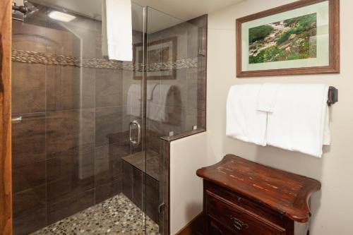 a bathroom with a shower with a glass door at Lodge at Whitefish Lake in Whitefish