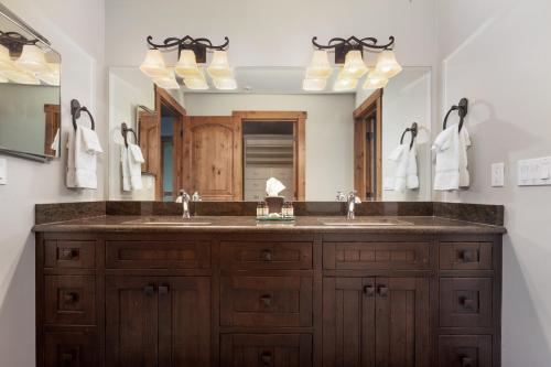 a bathroom with a sink and a large mirror at Lodge at Whitefish Lake in Whitefish