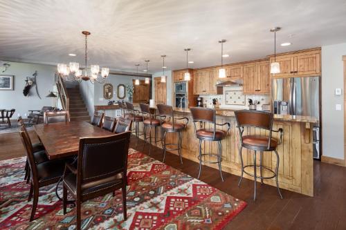 a kitchen and dining room with a table and chairs at Lodge at Whitefish Lake in Whitefish