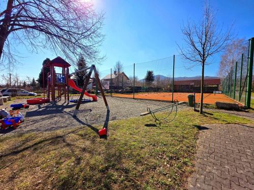 a playground with a swing set in a park at Ubytování Zaolší in Vendryně