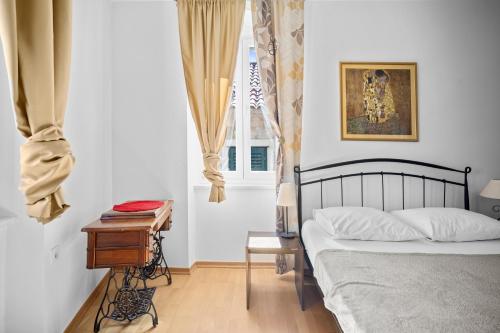 una camera da letto con un letto, un tavolo e una finestra di Apartment Bose a Spalato (Split)