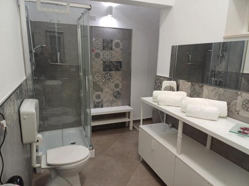 a bathroom with a shower and a toilet and a sink at Casa San Nicolò in Scicli