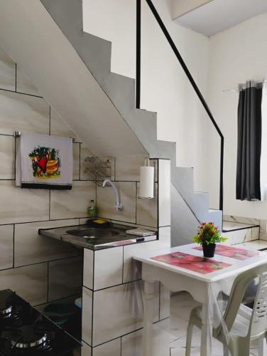 a kitchen with a sink and a table at Apartamento Cavalcante in Belém