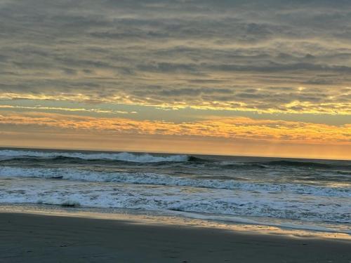 a beach with the ocean and the sky at Direct Ocean Front Townhouse! An oceanside gem perfect for any vacation! in Brigantine