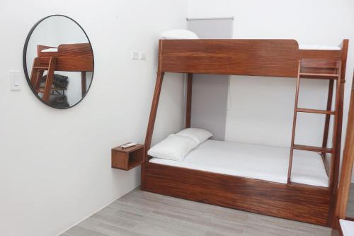 a bunk bed in a room with a mirror at Casa con Piscina y jacuzzi, vista al Volcán Tenorio in Martirio