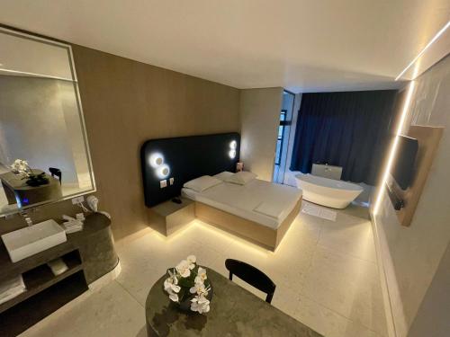 a large bathroom with a couch and a sink at Le Piège Motel Thematiquè in Almirante Tamandaré