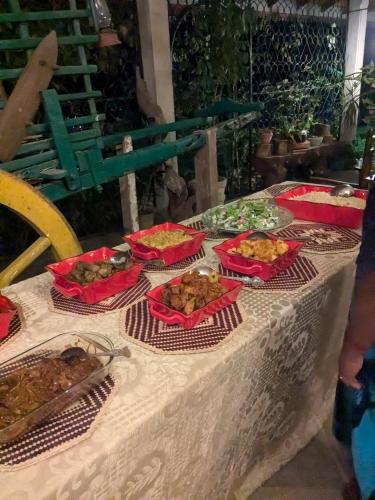 a table with several dishes of food on it at Namadi heights Bungalow in Kandy