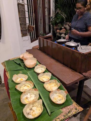 a table topped with food on top of a table at Namadi heights Bungalow in Kandy