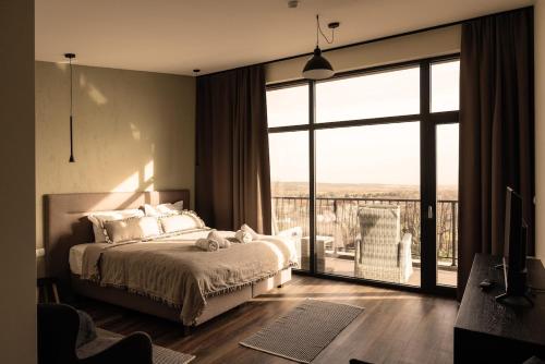 a bedroom with a bed and a large window at Luxury House Veles in Hisarya