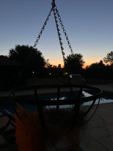 a swing in a playground with the sunset in the background at Cheerful and cozy Bungalow with pool and fireplace in Athalassa