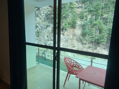 a view from a window of a table and chair at Hotel Birmingham Palace Kalam by Khan Familia Travels in Kalām