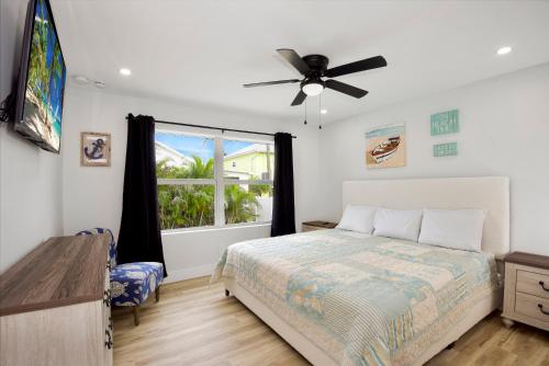 a bedroom with a bed and a window at Anchors Away by Sun Palace Vacations in Fort Myers Beach
