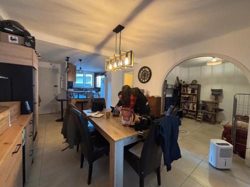 une femme assise à une table dans une cuisine dans l'établissement Les Naïades, à Antibes