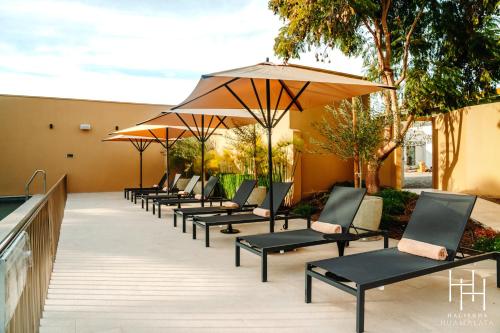 a row of chairs with umbrellas on a patio at Hacienda Huamalata in Ovalle
