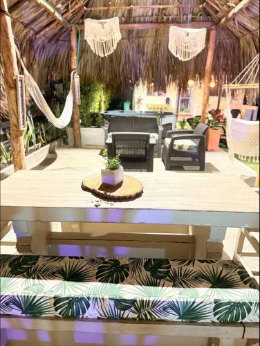 a patio with a hammock and a table at Cabaña Las Tres Palmas in San Bernardo del Viento in San Bernardo del Viento