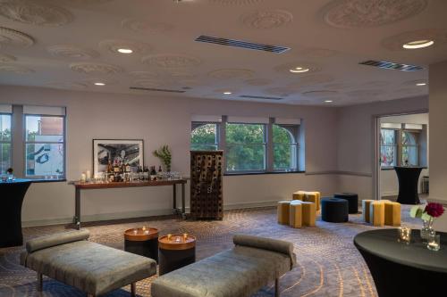 a waiting room with couches and a bar at Renaissance Des Moines Savery Hotel in Des Moines