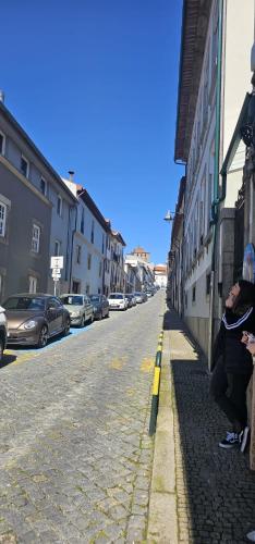 a group of people sitting on the side of a street at Urban Lodge in Braga