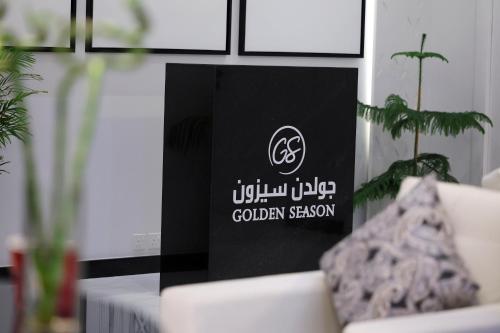 a black and white sign in a room with a couch at Golden Season Hotel - Al-Rass - فندق جولدن سيزون - الرس in Al Rass