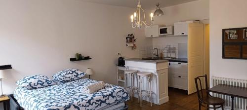 une petite chambre avec un lit et une cuisine dans l'établissement La Suite Sinatle Rennes Hyper Centre - 2 personnes, à Rennes