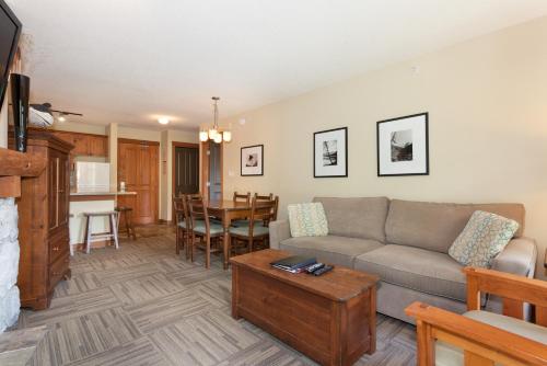 a living room with a couch and a table at Lost Lake Lodge by Whistler Premier in Whistler