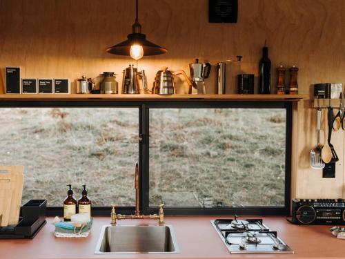 a kitchen counter with a sink and a window at Off-Grid Cabin with Valley Views and Hot Tub - Velma in Tarra Valley
