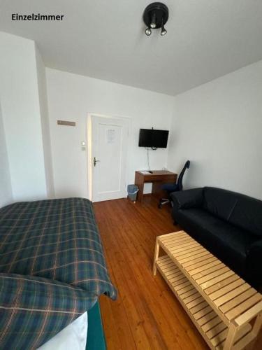 a living room with a bed and a couch at Apartments & Zimmer Jembke in Jembke