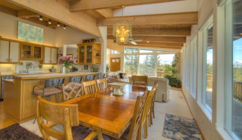 a dining room and kitchen with a wooden table and chairs at Enviable Lake & Mountain Views Wth Waterfall in South Lake Tahoe