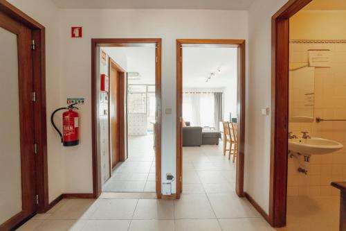 a hallway with two doors and a fire hydrant at Espinho Modern 3 Bedroom Apartment by Vacationy in Porto