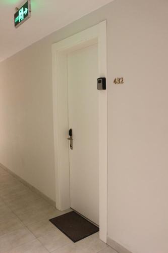 a door in a room with a clock on the wall at Your Cozy Apartment in New Gudauri, Loft 2 #432 in Gudauri