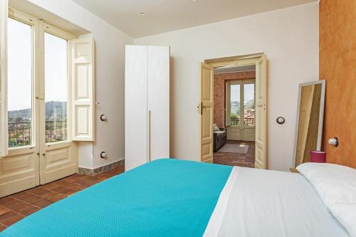 a bedroom with a large bed with a blue blanket at B&B Badimà in Fleri