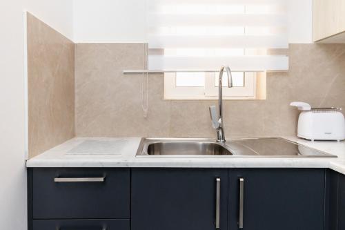 a kitchen with a sink and a counter top at Luigi penthouse in St. Paul's Bay