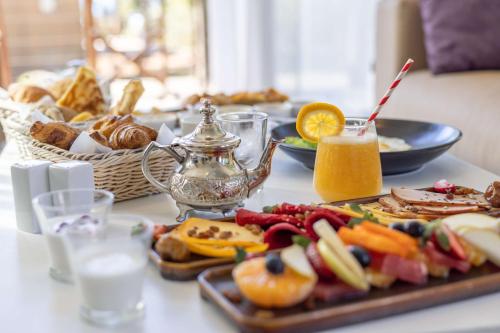 a table with a tray of food and a drink at Radisson Blu Resort Taghazout Bay Surf Village in Taghazout