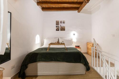 a bedroom with a bed in a white room at Dimora Berardino in Triggiano