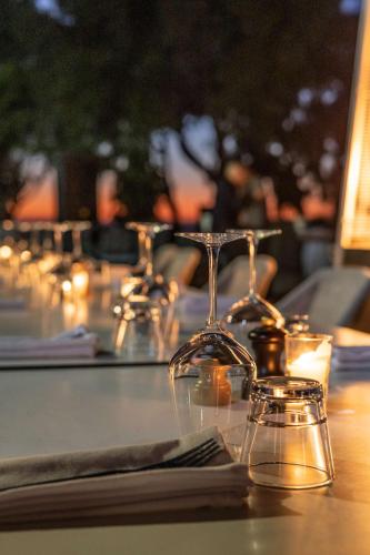 a table with wine glasses and candles on it at Radisson Blu Resort Taghazout Bay Surf Village in Taghazout